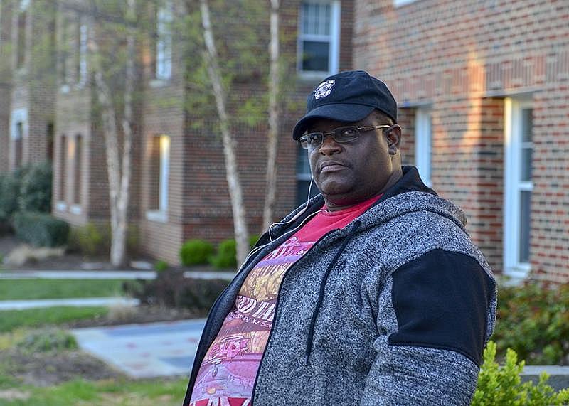 Leon Lightfoot, who has lived in Dahlgreen Courts Apartments with his family since 1999, stands in front of the building. Lightfoot said that his wife and son have asthma and that he has headaches and other respiratory problems. (Freddie Allen/AMG/NNPA)