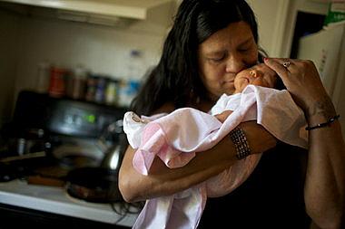 Candida KingBird cradles her daughter, Mishiike Meteh McQuakay KingBird, at their home in East Portland, six days after the baby is born. 