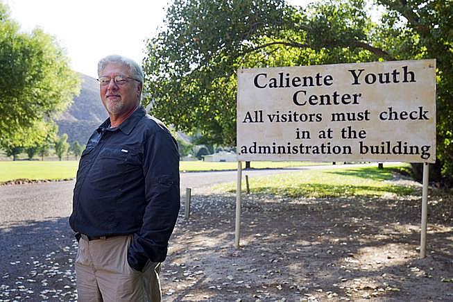 Steve Marcus - Psychiatrist Norton Roitman poses at the entrance at the Caliente Youth Center in Caliente, Nev., about 150 miles north of Las Vegas,Tuesday, Sept. 8, 2015.