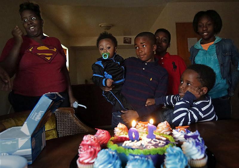 Shanette Upchurch (left) starts the singing to celebrate her son Tashaun’s 10th birthday in November at their home in Riverview. Tashaun (center) holds his nephew Quintin Tobias Jr., 1. Five years ago, after her youngest child was born, Upchurch signed up for home visits and therapy, and joined a support group. She said the group changed her outlook on life and parenting.