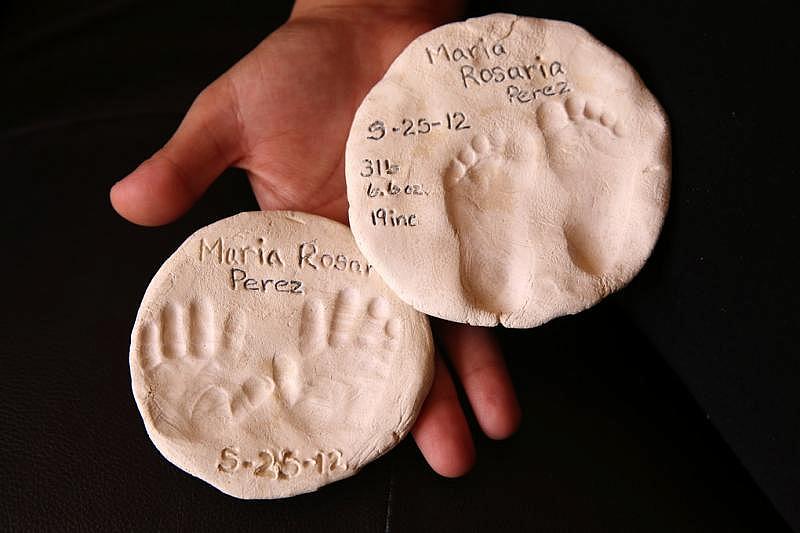 Sally Garcia keeps casts of Maria’s hands and feet. Prosser funeral director Carlen Majnarich said she buried several babies with anencephaly this year. “It’s very hard,” she said. “All of those lost hopes for a child.” (Erika Schultz / The Seattle Times)