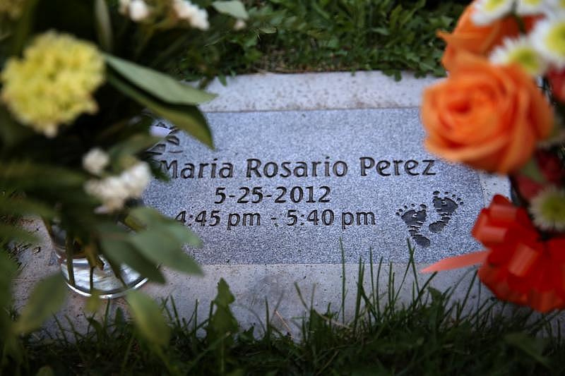 Every two weeks, Sally Garcia buys fresh flowers at the local Food Depot to take to her daughter’s grave. (Erika Schultz / The Seattle Times)