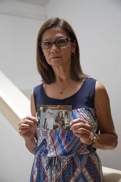Lydia Nunez holds a photo of her son Ruben. (Lisa Pickoff-White/KQED)