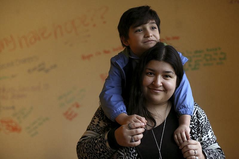 Jessica Alcala stands with her son, Jose Hernandez, 6, at the Restoration Center where she works as a drug abuse counselor. Alcala said health-care professionals often are judgmental of pregnant women with substance abuse disorders, which can deter women from seeking prenatal care.