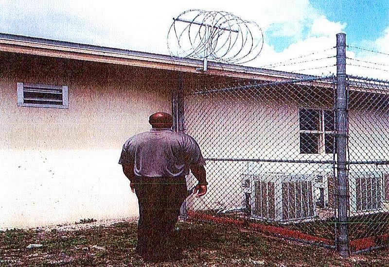 An officer examines the rooftop where Keyon Felder took refuge at Okeechobee Youth Development Center. Florida Department of Juvenile Justice