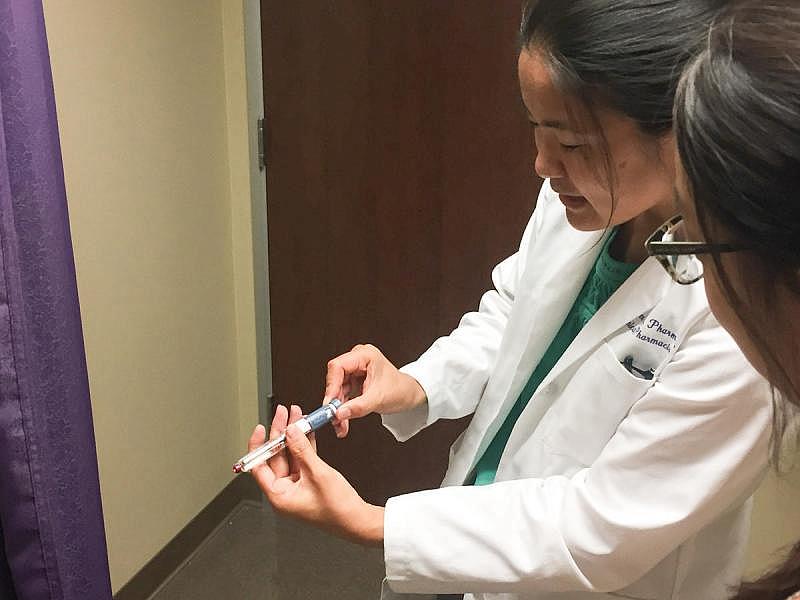 SB 493 now authorizes pharmacists to furnish some medications without a prescription and work directly with patients to manage their medications. In some settings, pharmacists are already permitted this expanded scope of practice—including Jennifer Toy, a pharmacist at Kaweah Delta Medical Center shown here demonstrating how to use an insulin pen. Credit Matt Heinsen