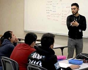 Fidel Parra, a junior at California State University, Sacramento and also a student teacher with the California Mini-Corps, tutors a group of high school students in English during the Dixon Unified School District Migrant Education Program. Joel Rosenbaum — The Reporter 