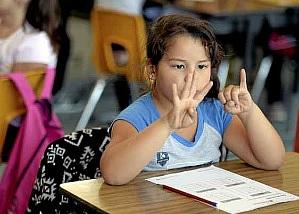 Using her fingers to help her with her addition, Angela Aguirre, 7 works on a math problem Monday in Elizabeth Brown’s first grade class at Anderson Elementary School. The class is part of Dixon Unified’s summer migrant education program. Joel Rosenbaum -- The Reporter 