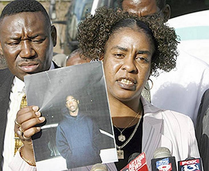 Gina Jones holds a photo of her son Martin Lee Anderson taken just before he entered a Panhandle boot camp. In 2006, he stopped breathing during a restraint at the camp while a nurse stood by and declined to help. Ken Helle-Tampa Bay Times