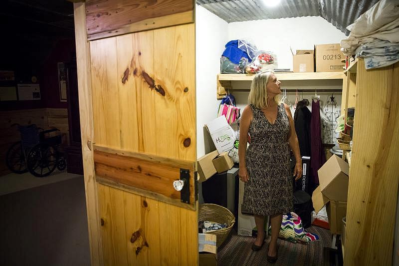 Candace Stark stands in the closet at her father’s La Grange home, where she found a kissing bug. (Smiley N. Pool/Staff Photographer)
