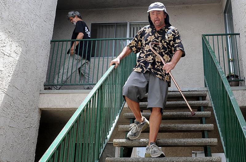 Daryl McGee (left), 48, was living at the pier for the past 20 years and his roommate Monty Monkress (right), coming down the stairs, are now off the streets and share an apartment.