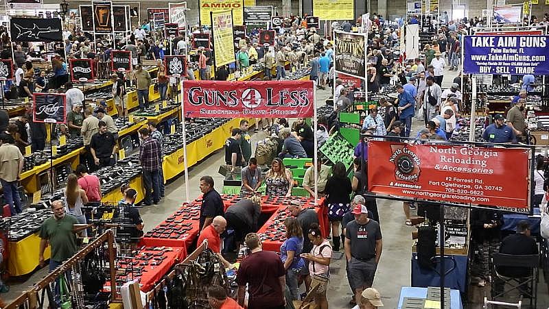 Gun shoppers browse the Florida Gun Show’s booths at the Florida State Fairgrounds in December. Legal firearm sales are on the rise.