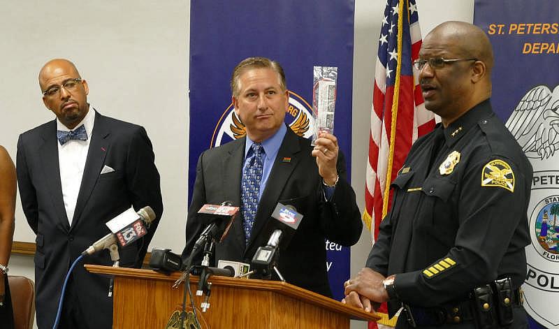 St. Petersburg Mayor Rick Kriseman, holding a gun lock, center, along with St. Petersburg Community Intervention Director Ken Irby and Police Chief Anthony Holloway talk about how to curb gun violence during a press conference in 2016. The city offers free gun locks to residents.