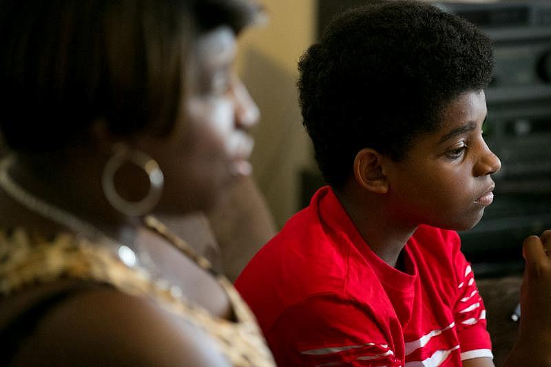 Lisa Clark, with son Deon, worries about asbestos’ long-term effects on students. “Who’s to say that they won’t have a higher rate of cancer as adults?”