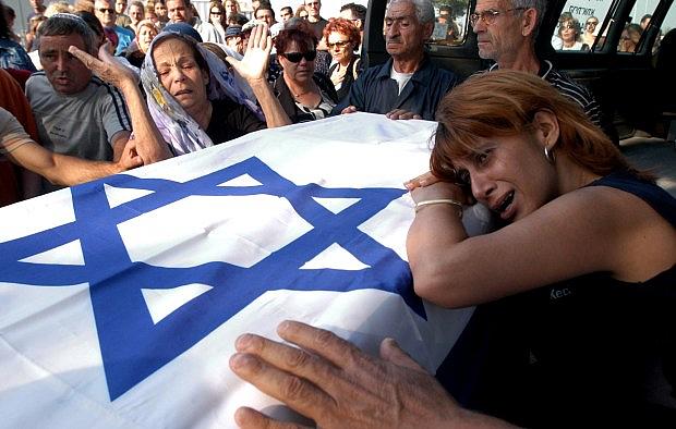 Relatives of Bat-El Ohana carry her coffin during her funeral in the cemetery of Kiryat Atta, near the northern city of Haifa, Israel, Thursday, June 12, 2003. Ohana, 21, was one of 16 people killed in Wednesday, June 11’s bus bombing in Jerusalem. (AP Photo/ Baz Ratner) Relatives of Bat-El Ohana carry her coffin during her funeral in the cemetery of Kiryat Atta, near the northern city of Haifa, Israel, Thursday, June 12, 2003. Ohana, 21, was one of 16 people killed in Wednesday, June 11’s bus bombing in Jerusalem. (AP Photo/ Baz Ratner)