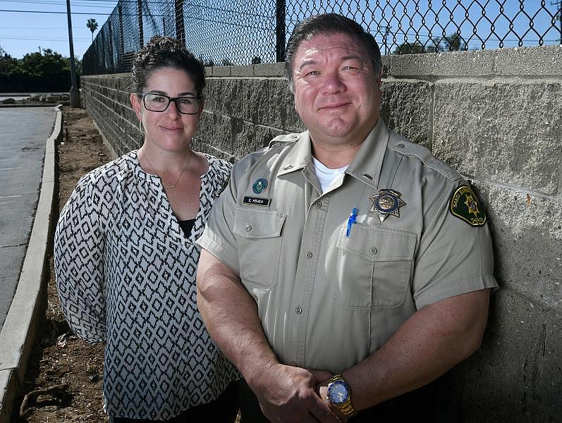 Eddie Hsueh was inspired by Batman to become a cop; he wanted to put bad guys in jail. Now he’s teamed up with clinician Cherylynn Lee (left) to help keep people with mental illness out of jail. Eddie Hsueh was inspired by Batman to become a cop; he wanted to put bad guys in jail. Now he’s teamed up with clinician Cherylynn Lee (left) to help keep people with mental illness out of jail.