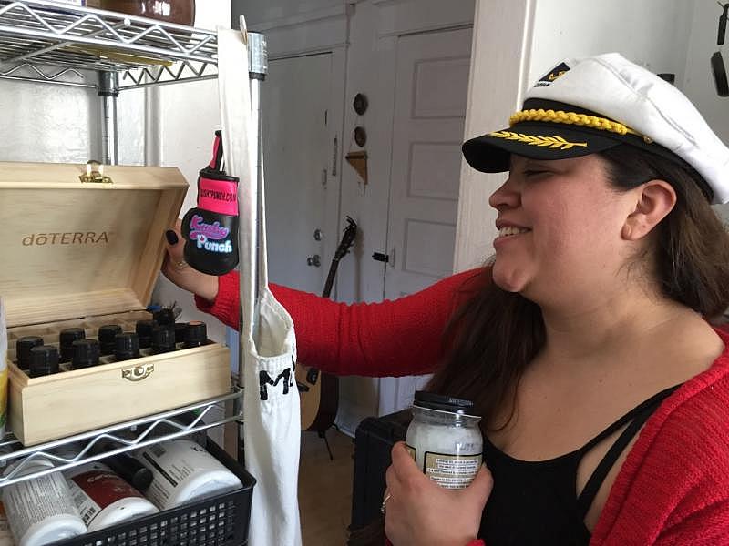 Carmen Morales shows some of the essential oils and herbal remedies she uses.