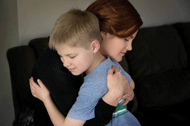 Jacob Shivers, 8, with his mother, Melissa Ann Shivers, at their home in Northeast Philadelphia. Jacob tried to wake up his classmate Lucas Sims after he became "unresponsive" during story time at Loesche Elementary.