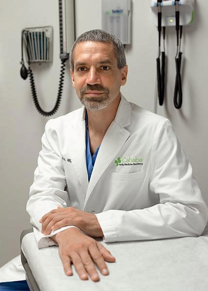 Dr. John Waits in the clinic he started with his partners.