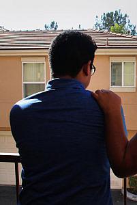 Edgar is comforted by his undocumented mother outside their home in Los Angeles. (COURTESY OF ROBERT DOLAN, SJ)