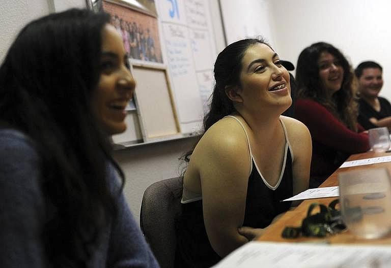 Maya Vannini, 17, left, and Gabrielle Rivas, 21, members of The Know Youth Media project, discuss sex education at a meeting Wednesday, Oct. 18, 2017 in Fresno.
