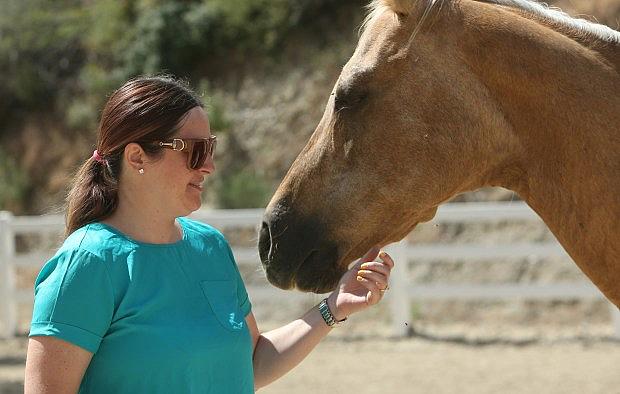 Paula Harold has a moment with Heidi, a horse she used in a horse therapy program through Equus Medendi Equine Assisted Therapy in Redlands on Wednesday, May 24, 2017. Paula is a survivor from the Dec. 2, 2015 terrorist attack in San Bernardino and is now dealing with PTSD. She has completed 12 sessions of the horse therapy program to help her deal with the issues. (Stan Lim, The Press-Enterprise/SCNG)