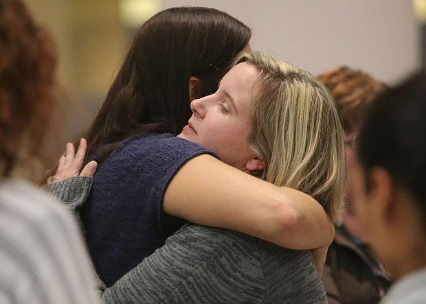 Sally Cardinale, a Dec. 2 shooting victim, right, is consoled by her sister, Angela Cardinale, of Redlands, at the end of a San Bernardino County Board of Supervisors’ special meeting regarding the workers’ compensation issues on Monday, Nov. 28, 2016. (Stan Lim, The Press-Enterprise/SCNG)
