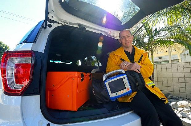 Dr. Clayton Kazan in the trunk of his work SUV, where he keeps a stash of medical supplies. (Photo by Scott Varley, Contributor)