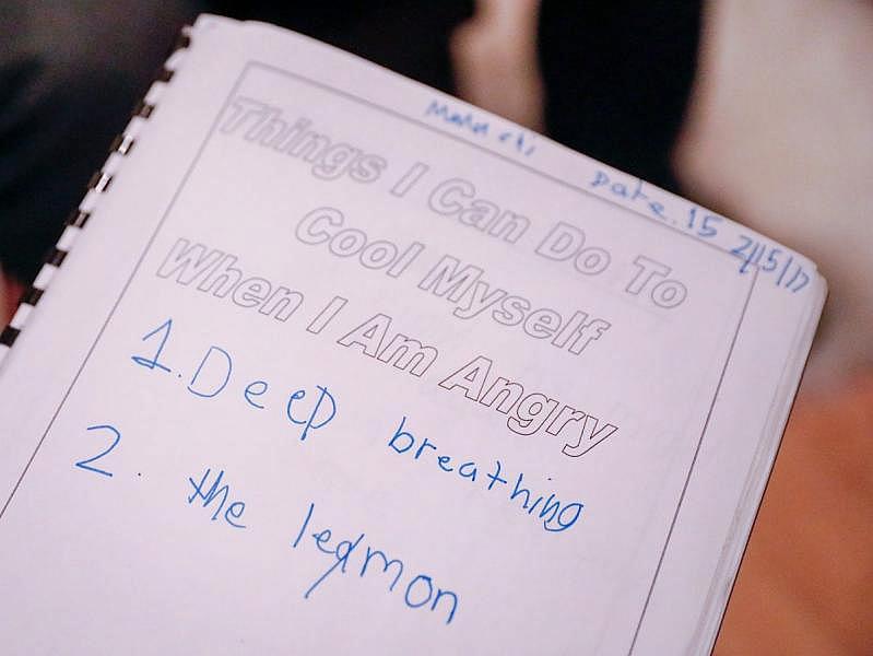 Malachi shows a workbook he used to help deal with the trauma he experienced in the aftermath of a shooting two years ago. Malachi shows a workbook he used to help deal with the trauma he experienced in the aftermath of a shooting two years ago.