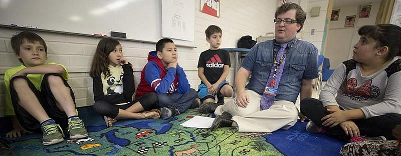 At Tully Elementary Magnet School, Nathan Taylor talks with his third-grade class about being a leader and follower. The class’s social-emotional curriculum emphasizes critical thinking, empathy and problem-solving, with the goal of helping students learn healthy ways to interact. Children need to understand that people experience things differently, Taylor stresses.