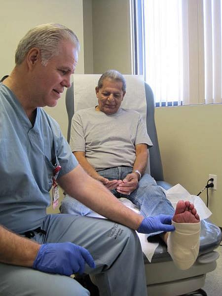 Dr. Stanley Mathis, co-director of the Center for Limb Preservation and Advanced Wound Care at Adventist Health White Memorial in Boyle Heights, checks Raul Rodriguez’s foot. (Francisco Castro)