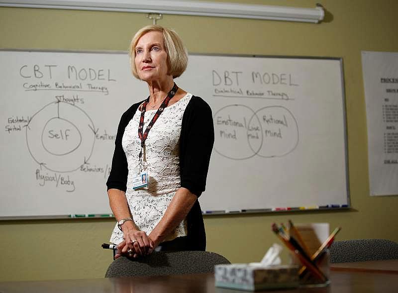  Peg Ledner-Spaulding, LCSW, manager of outpatient behavioral health services poses for a portrait in front on cognitive and dialectical behavior therapy diagrams that illustrate evidence-based tools taught to help people recover from mental illness, at the St. Joseph Health Santa Rosa Memorial Hospital Outpatient Behavioral Health Services clinic in Santa Rosa, California, on Wednesday, August 16, 2017. (Alvin Jornada/The Press Democrat)