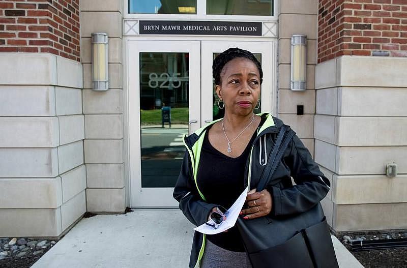 Sharon Bryant, a teacher at the Cassidy school, leaves a medical office after her ear, nose, and throat doctor told her she needs additional testing due to asbestos exposure.