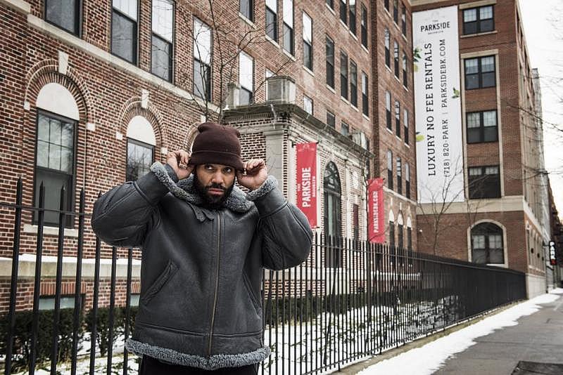 Brooklyn resident Sinaka Garcia stands in front of the hospital he was born. Two-bedroom apartments at the former hospital, which now is a luxury building called The Parkside Brooklyn, rent for upward of $4,000.