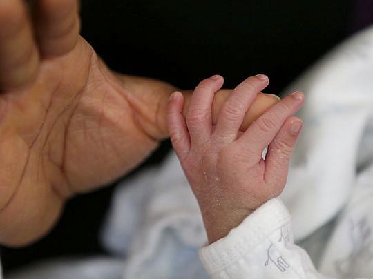 Tonda Thompson holds her newborn son, Jehlani Rashid, at her home in Milwaukee. Thompson, who has experienced the loss of an infant child, is now happy to have a healthy baby.