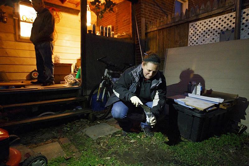 Melissa Billingsley, a state-licensed risk assessor for Criterion Laboratories, takes a soil sample in a yard located on the 2600 block of East Thompson street. The yard tested high for lead.