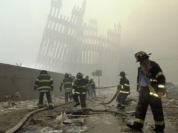FILE – In this Sept. 11, 2001 file photo, firefighters work beneath the destroyed mullions, the vertical struts which once faced the soaring outer walls of the World Trade Center towers, after a terrorist attack on the twin towers in New York. (AP Photo/Mark Lennihan) FILE – In this Sept. 11, 2001 file photo, firefighters work beneath the destroyed mullions, the vertical struts which once faced the soaring outer walls of the World Trade Center towers, after a terrorist attack on the twin towers in New York. (AP Photo/Mark Lennihan)