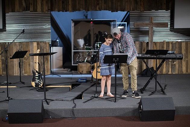 Caleb Hacker and his sister, Olivia Agnew, reading music at the Lakewood Baptist Church (Jesse Pratt Lopez)