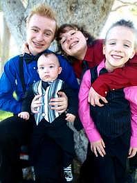 Gabe, second from right, wraps his arms around his younger brothers during a family photo shoot in August.