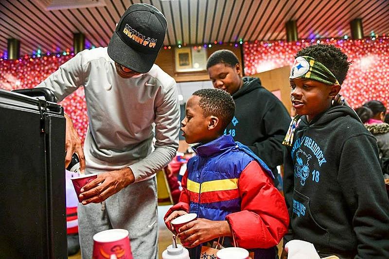 Demont Coleman, former mayor of Rankin, left, puts whipped cream on a hot chocolate as Eric Ramsey, center, and Tyshawn Champine, right, both of Rankin, look on during the Rankin Borough Holiday Night, Dec. 12, in the borough building. Demont Coleman, former mayor of Rankin, left, puts whipped cream on a hot chocolate as Eric Ramsey, center, and Tyshawn Champine, right, both of Rankin, look on during the Rankin Borough Holiday Night, Dec. 12, in the borough building.