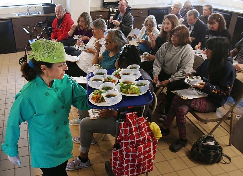 Glenda Garcia brings out samples of the cooking class product during a Fit First Saturday at The Garden Kitchen, 2205 S. Fourth Ave. The program is part of Healthy South Tucson and features a physical activity, cooking class and gardening instruction.