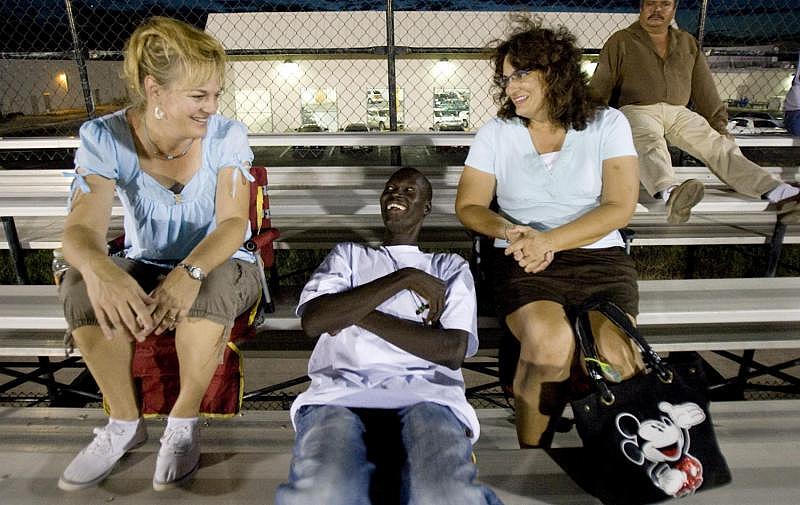 Ochor Odol, then 17, joked around with Kathy Teel, left, and Deanna Campos at Amphitheater High in 2010. Teel and Campos were guardians of Ochor and his younger brother.