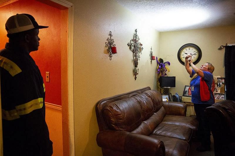 Montalvo photographs mold growing on Michael Brown's living room ceiling in Refugio. Brown, 38, has attempted to repair his hurricane-damaged home himself without success. [Photo by Angela Piazza]