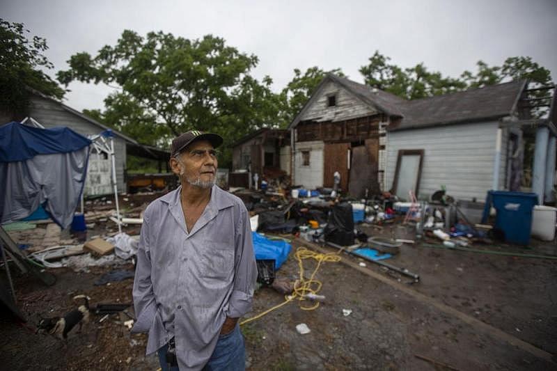U.S. Army veteran Reynaldo Garza, 70, stands in front of his house at 305 Locke St. in Woodsboro. The home was destroyed in Hurricane Harvey, forcing Garza to live in his vehicle.