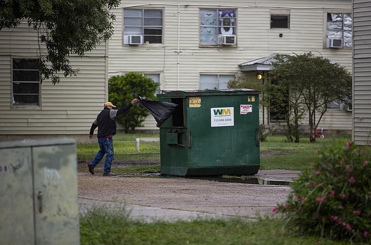 A Crossroads maintenance worker throws a black garbage bag filled with items he collected from Gary and Johnson’s apartment into a dumpster. The bag was one of several that ended up in the garbage. Without giving Gary an exact time, the crew let themselves into her apartment and cleared all of the family’s belongings out in about an hour.