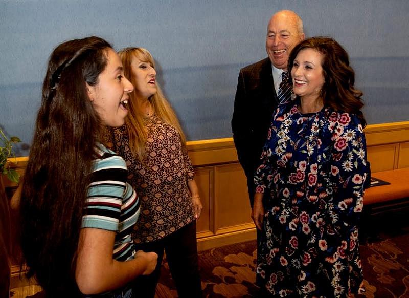 Elainna Estrada, 14 and her mom Yvette, left, talk with Toni and John Ginger at the Ambassador Luncheon for the Orangewood Foundation in Costa Mesa, CA on Friday, November 2, 2018. The Gingers received the General William Lyon Crystal Vision Philanthropy Award for their more than 20 years of foster parenting. Elainna was one of the kids they fostered from her birth until about 3 months old. (Photo by Paul Bersebach, Orange County Register/SCNG)