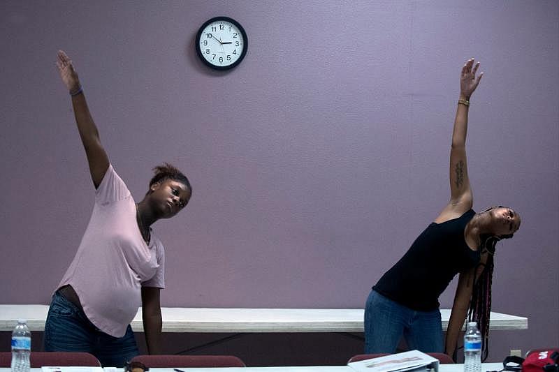 Dankia Williams, 30, left, and Jazmine Davis, 25, stretch after meditation during a Black Infant Health program held at Living Way Community Church in Moreno Valley on Wednesday, Oct. 17, 2018. Both live in Corona. (Photo by Cindy Yamanaka, The Press-Enterprise/SCNG)