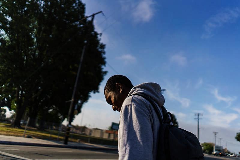 Carl Hull, a 10th-grader at Dymally High School, follows a route he feels is safest to get to school. (Marcus Yam / Los Angeles Times)