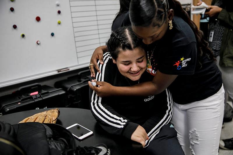 Jaleyah Collier hugs her friend Shelsea Reyes, 17.
