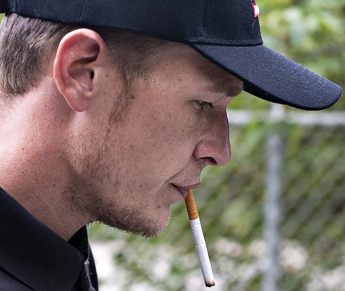 Travis Litts smokes a cigarette on a walk in Lansford. Rick Kintzel / The Morning Call